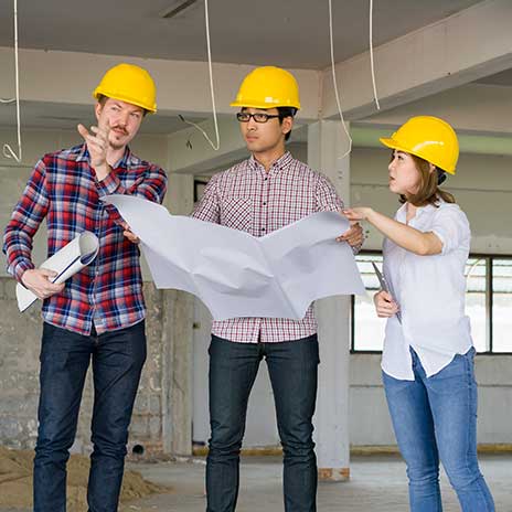 A construction team reviews plans on a job site